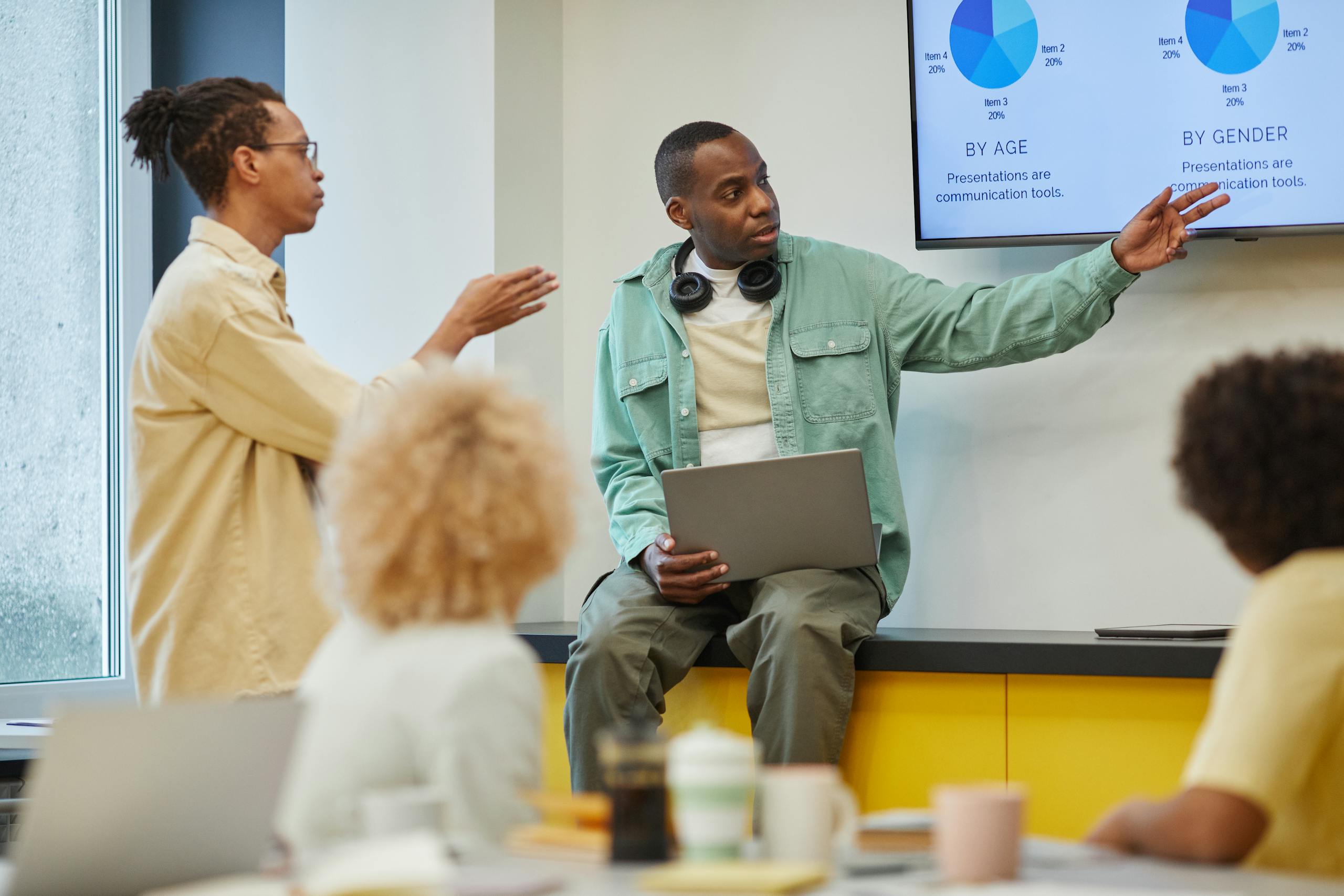 A team collaborates on a statistical presentation in a modern office setting.